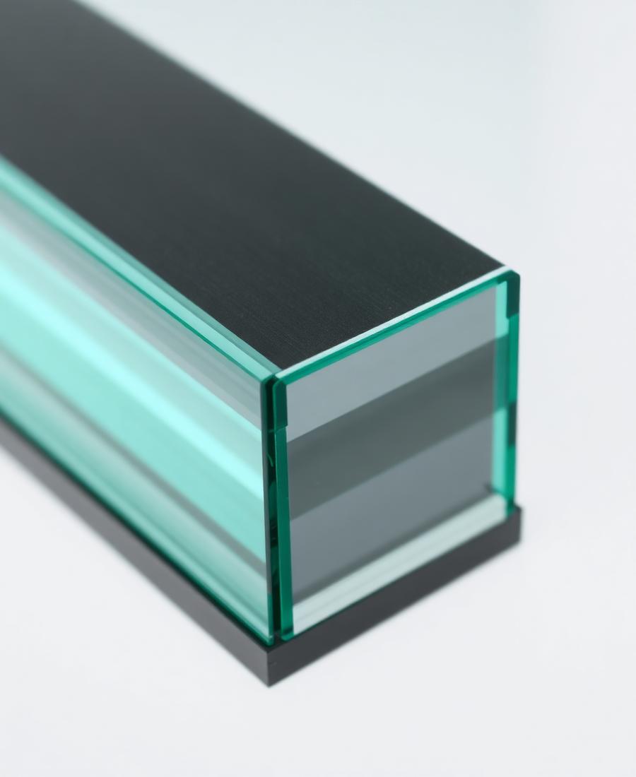 Macro detail of triple-glazed glass panel edge in a slim dark aluminium frame